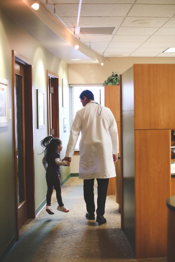 Dr. Arvind Petrie with a young patient at his Tacoma dental office