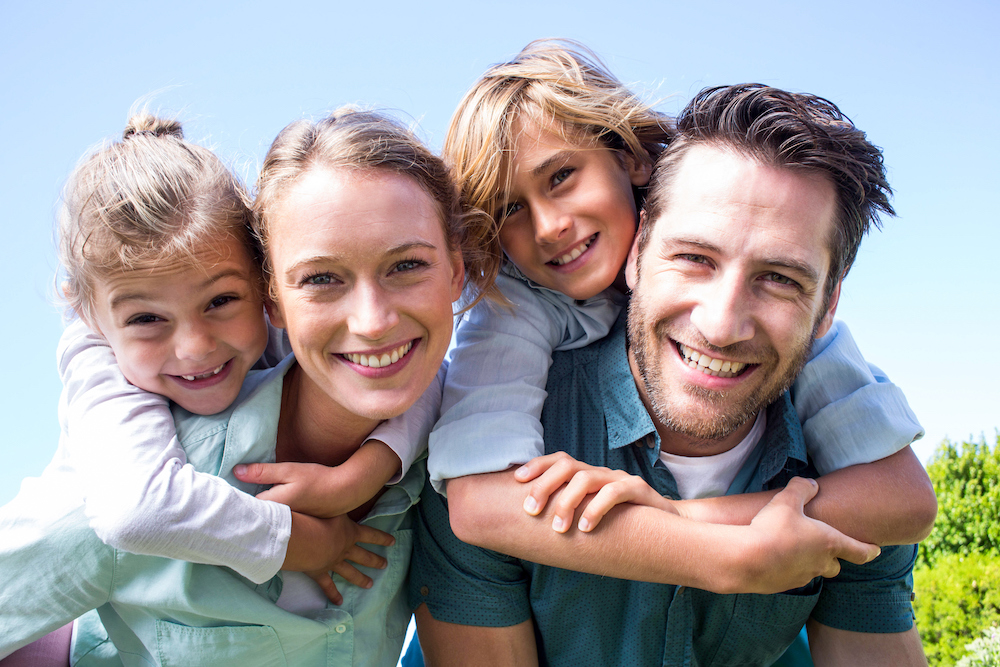 Family of four all smiling