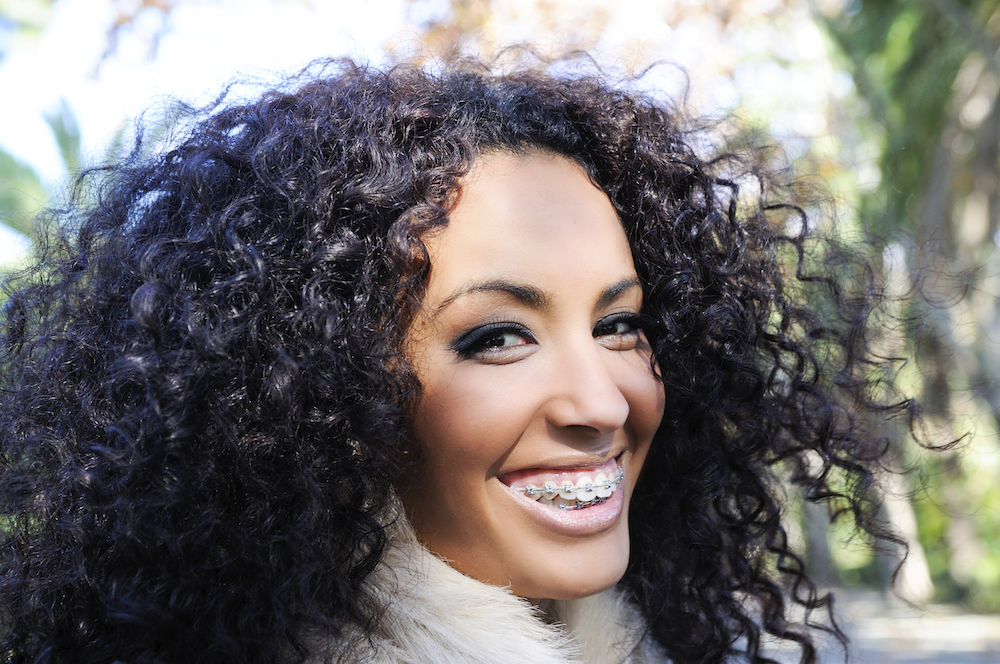 Young woman laughing with braces