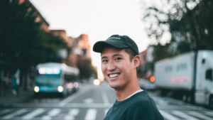 Young man smiling while crossing a street