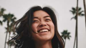 Young woman smiling amongst the palm trees