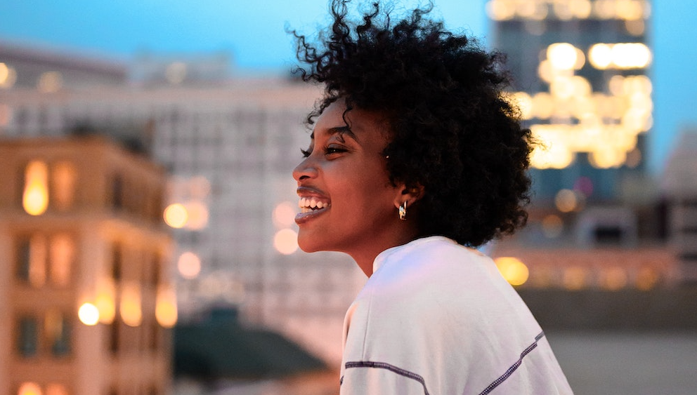Young woman laughing on a rooftop