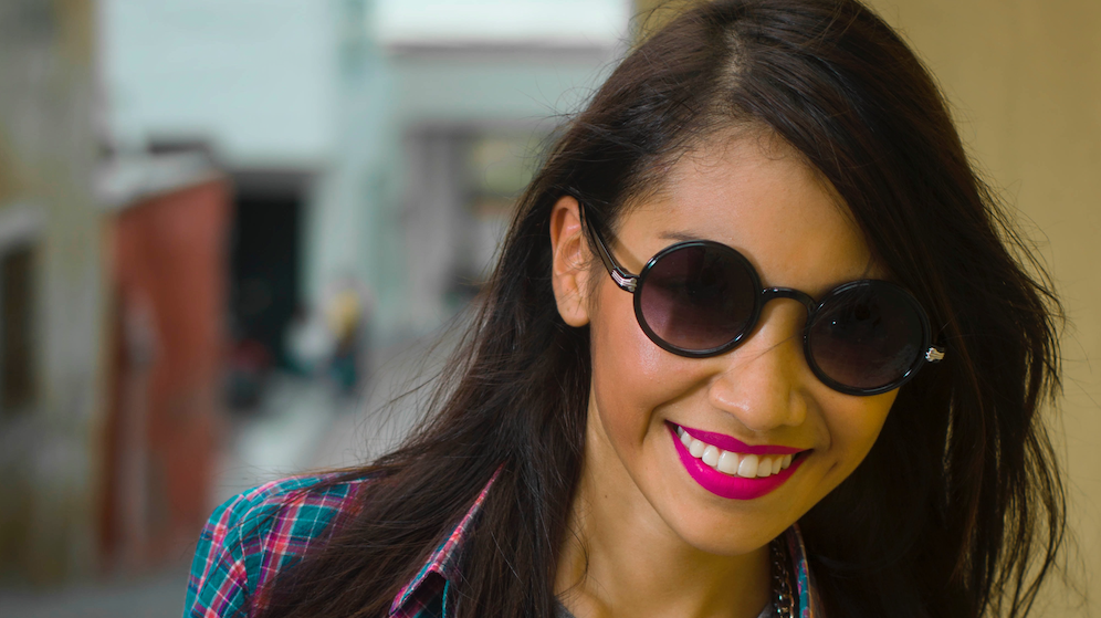 Young woman wearing sunglasses and smiling