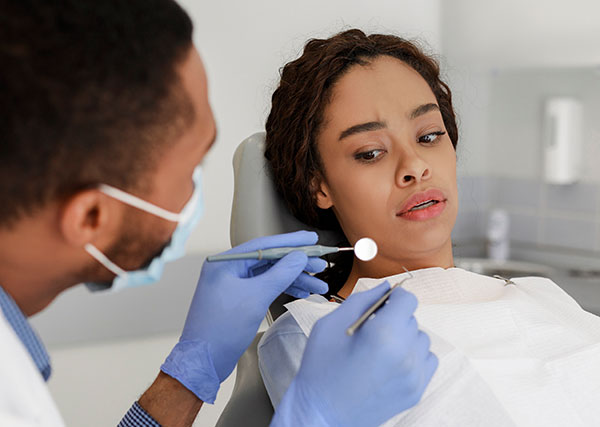 young lady looking scared at the dentist